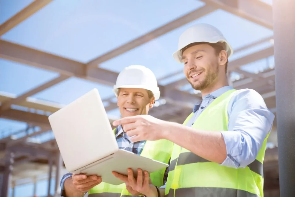 Builders reviewing project Acnhor